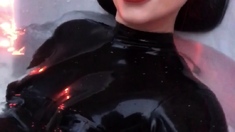 Dhorny redhead in latex sucks a huge penis