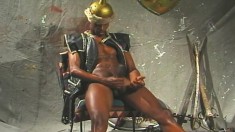 Dark skinned gladiator shows off his body and plays with his big stick