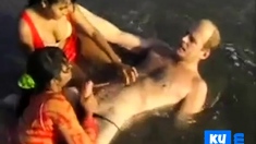 2 Indian girls with white guy in beach have fun blowjob..